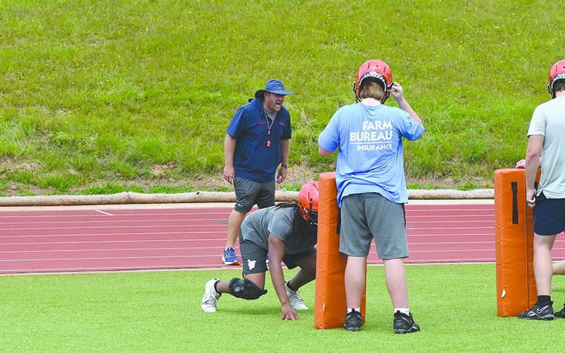 Coach Cody Honeycutt calls out assignments to linemen at practice Monday. LANG STOREY/Staff