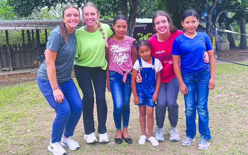 Habersham students Laci Fitzgerald, Ava Smith and Kyia Barrett befriend other children as part of their trip. KYIA BARRETT/Submitted