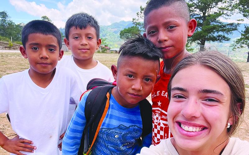 Kyia Barrett takes a selfie with a group of Honduran children during her mission trip with Level Grove Baptist Church. KYIA BARRETT/Submitted
