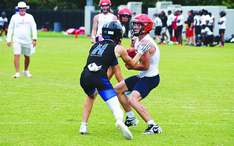 Habersham Central’s Landyn Savage gets snagged up by a LaGrange defender during 7-on-7 camp Wednesday. LANG STOREY/Staff