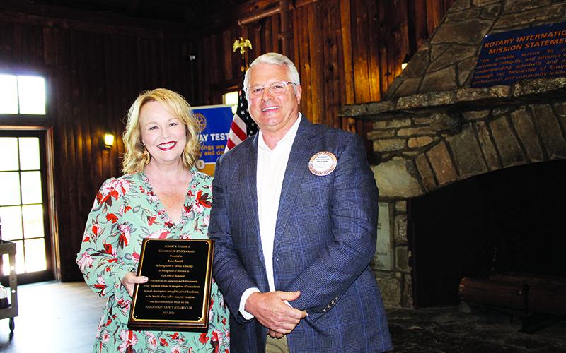 Lisa Smith is given the Robert S. Stubbs Guardian of Ethics Award by Habersham Rotary Club President Bradley Cook. BRIAN WELLMEIER/Special