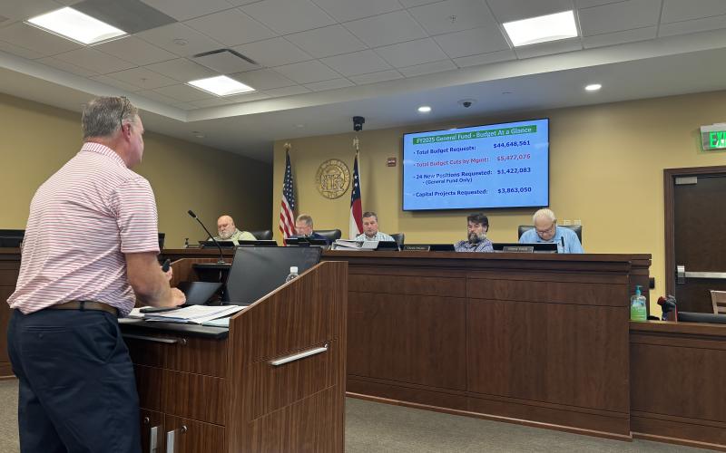County CFO Tim Sims explains the budget consensus to the commissioners Monday.