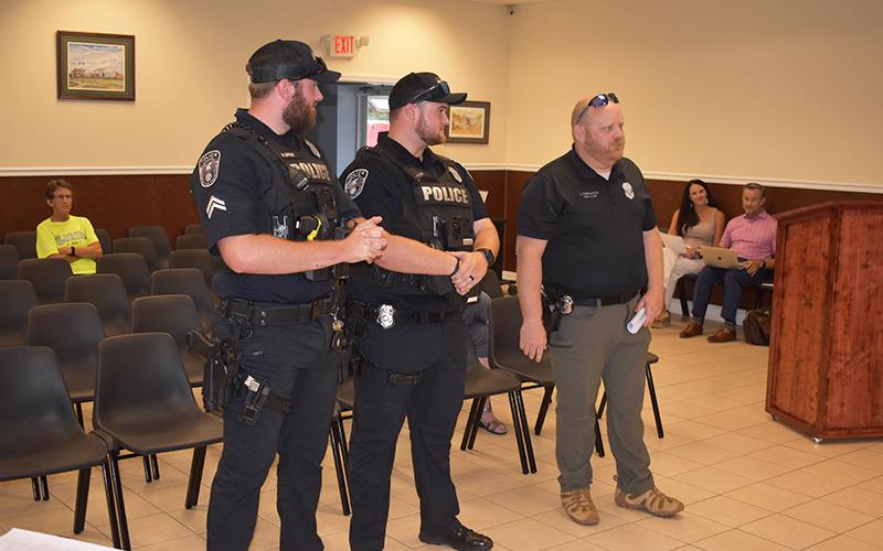 Baldwin  Assistant Police Chief Justin Ferguson (right) and Sgt. Aaron Spivey (left) introduce new officer Logan Ivester to the city council Monday.