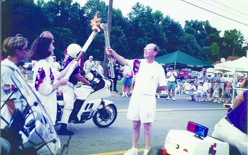 Dr. Martha Cantrell passes the Olympic flame to Community Bank &amp; Trust President Charlie Miller in 1996. Below, Cantrell got to keep her torch to mark the historic moment. SUBMITTED