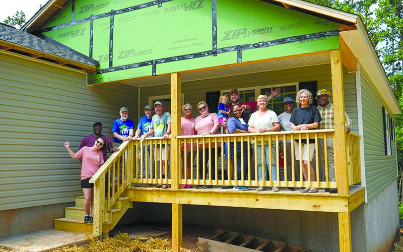 Volunteers celebrate the completion of a recent Habitat for Humanity build in Demorest. SUBMITTED