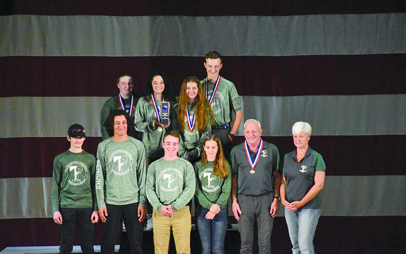 Tallulah Falls’ national championship rifle team included (front row, from left) Zeek Pruitt, Marc Crotta, Ethan Simmons, Kylee Loudermilk, coach Tim Stamey and assistant coach Kerry Stamey. Back row are (from left) Leah Rogers, Brianna Walter, Chloe Erwin and Joseph McGahee. Right photo shows the trophy the Indians brought home. TALLULAH FALLS SCHOOL/Submitted