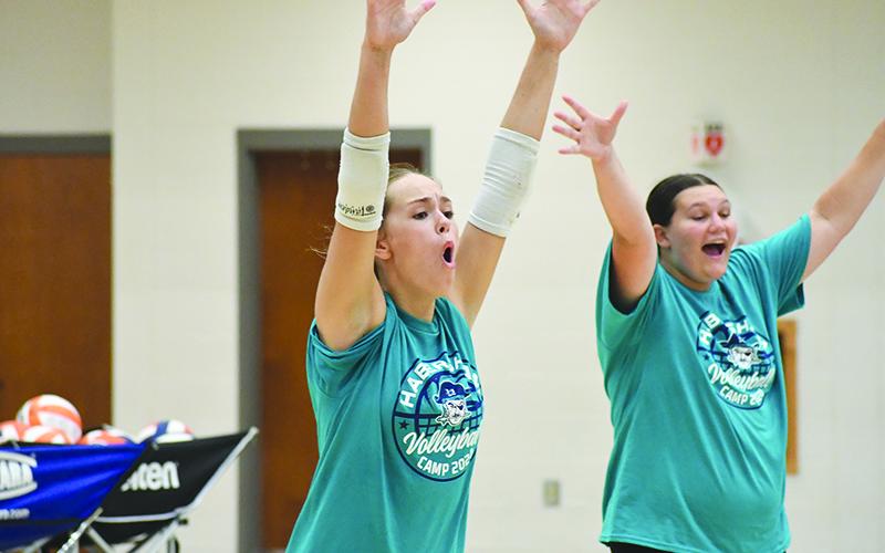 Jayden Jarrett (left) and Callyn Chosewood get loud after an ace by their team. LANG STOREY/Staff