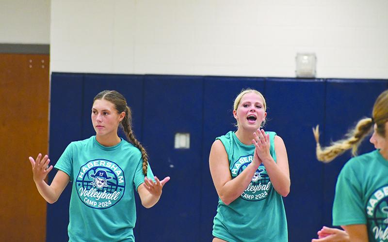 Ava Saxon (left) and Kenzie Hicks hype up their teammates during 6-on-6 play at volleyball All-American camp this week. LANG STOREY/Staff