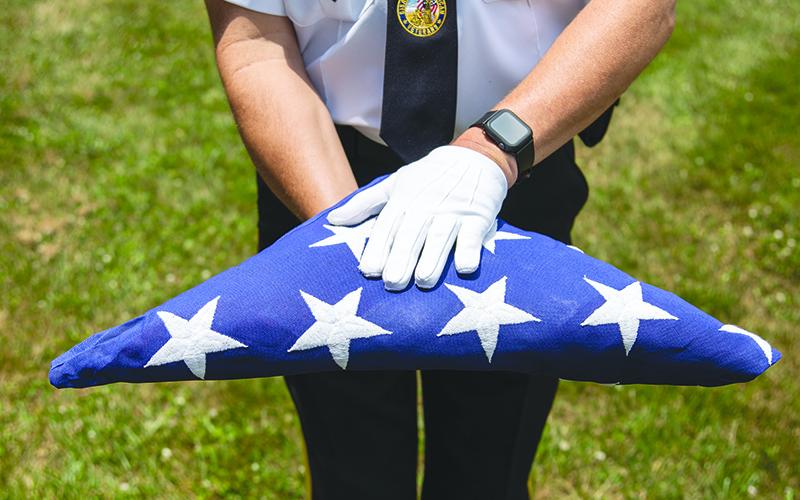 DAV Commander and Honor Guard member Jim Morgan presents the flag wearing white gloves. ZACH TAYLOR/Special