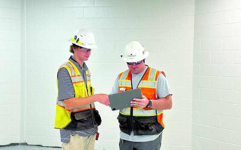 Jack Horton and Drew Atha discuss plans for renovations at Clarkesville Elementary construction site. CARROLL DANIEL CONSTRUCTION/Courtesy