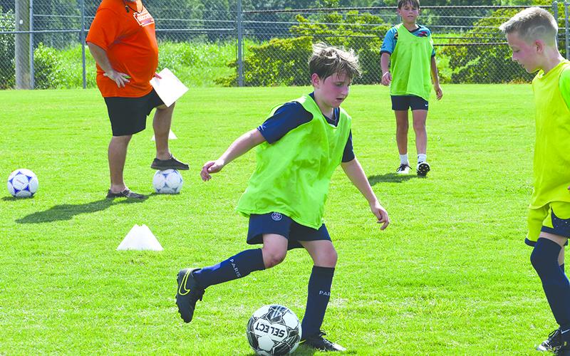 Jackson Aldrich protects the ball at Raider soccer camp earlier this week. LANG STOREY/Staff