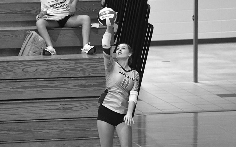 Jayden Jarrett serves the ball into play in the Lady Raiders’ match against East Jackson. LANG STOREY/Staff