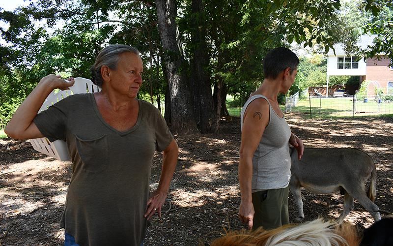 Nancy Romer, left, and Jessie Romer feed their many animals fresh fruits and veggies. JULIANNE AKERS/Staff