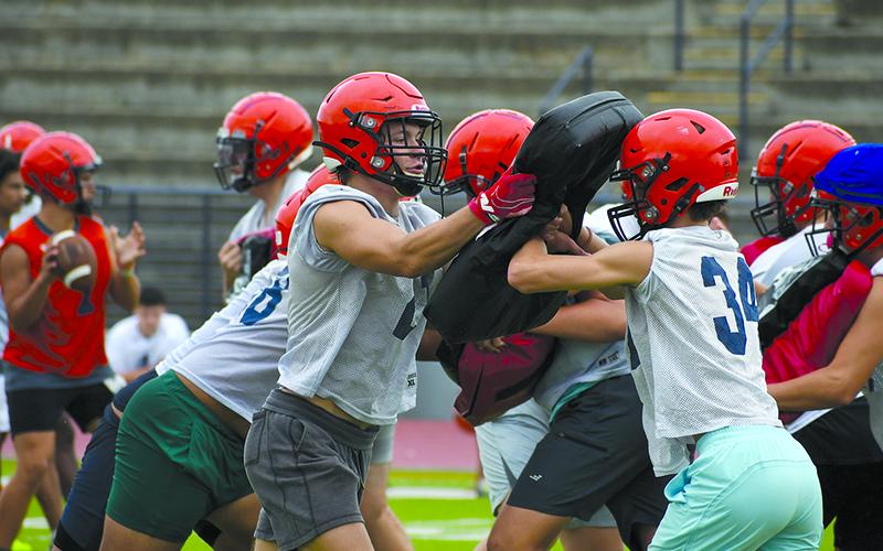 Habersham Central’s Landyn Savage (left) makes a block during practice on July 25. The Raiders host Oconee County for a scrimmage on Friday night. LANG STOREY/Staff