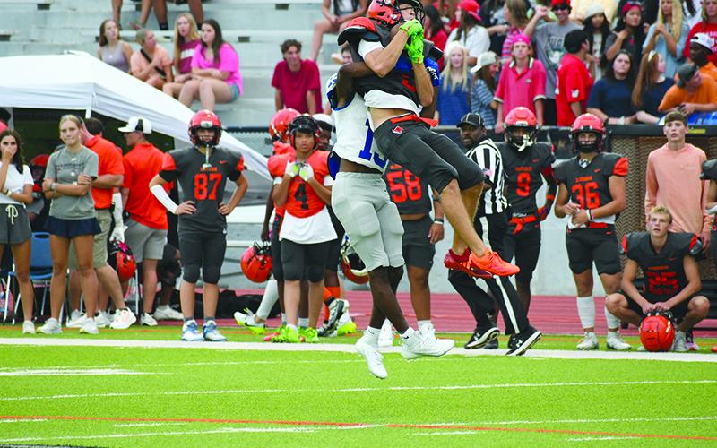 Habersham Central’s Zeke Whittington outleaps an Oconee defender for a catch. LANG STOREY/Staff