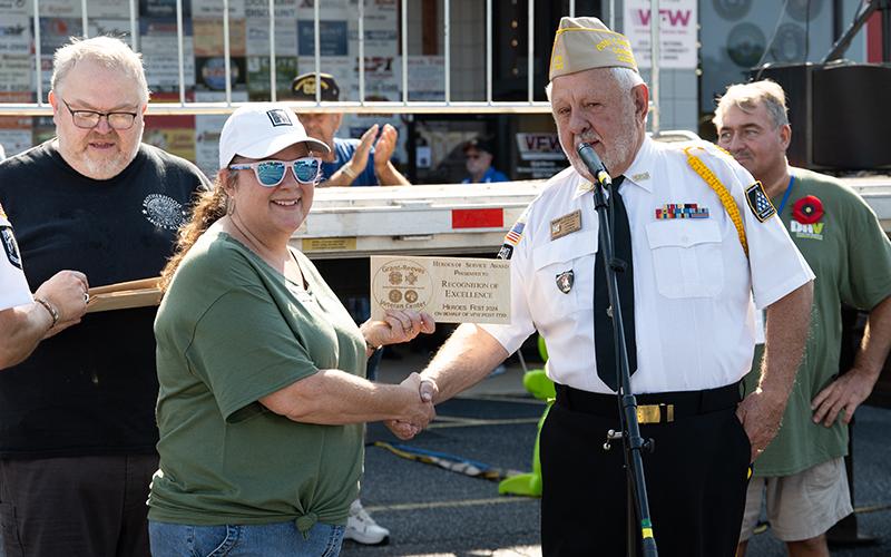 Commander Church presents Habersham Chamber of Commerce President Ellie Van Doornum with a Heroes of Service Award. ZACH TAYLOR/Staff
