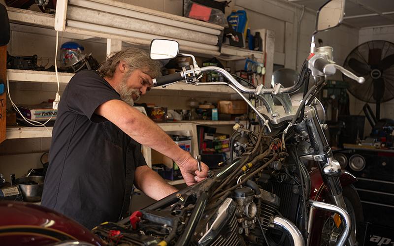 Pardue wrenches on a bike in the shop. ZACH TAYLOR/Staff