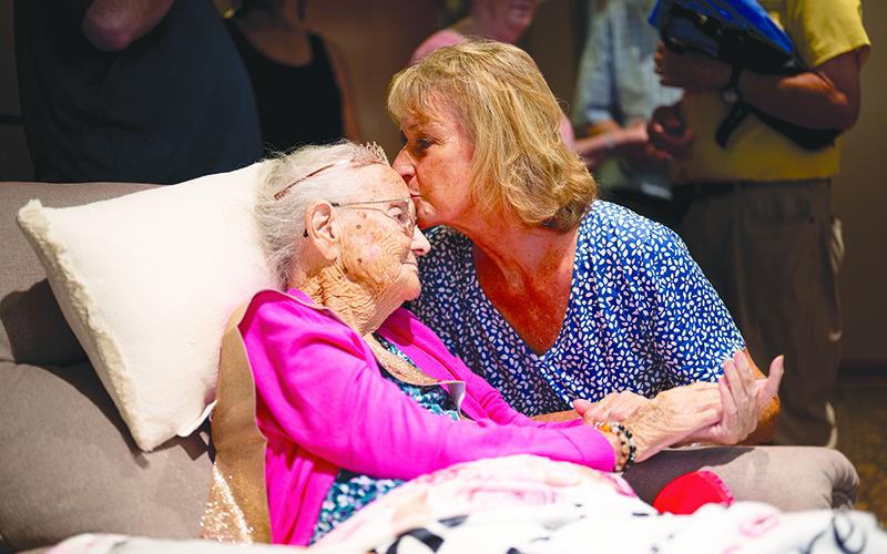 Shown here, Rhonda Vinson kisses Chastain on the forehead when visiting during the party hosted at Habersham EMC on Sunday. ZACH TAYLOR/Special