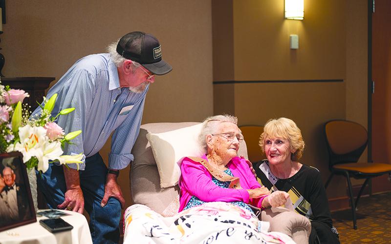 Thelma Shook and Bud Chastain, niece and nephew of Rosa Lee Chastain, crouch and lean beside her for a photo during her 100th birthday party Sunday. ZACH TAYLOR/Special