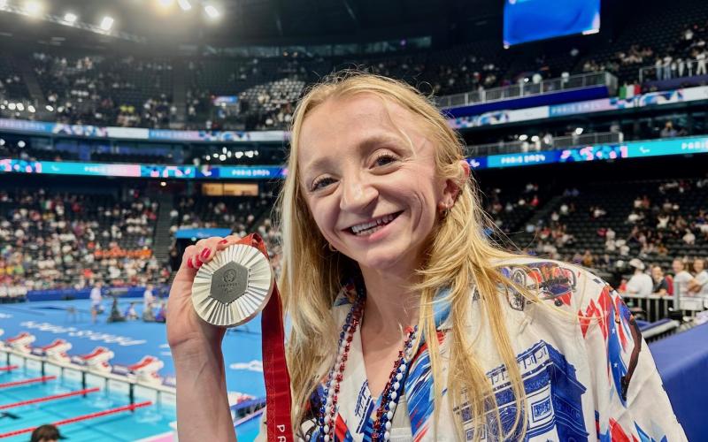Coan shows off her medal at the Paris Games this summer. SUBMITTED