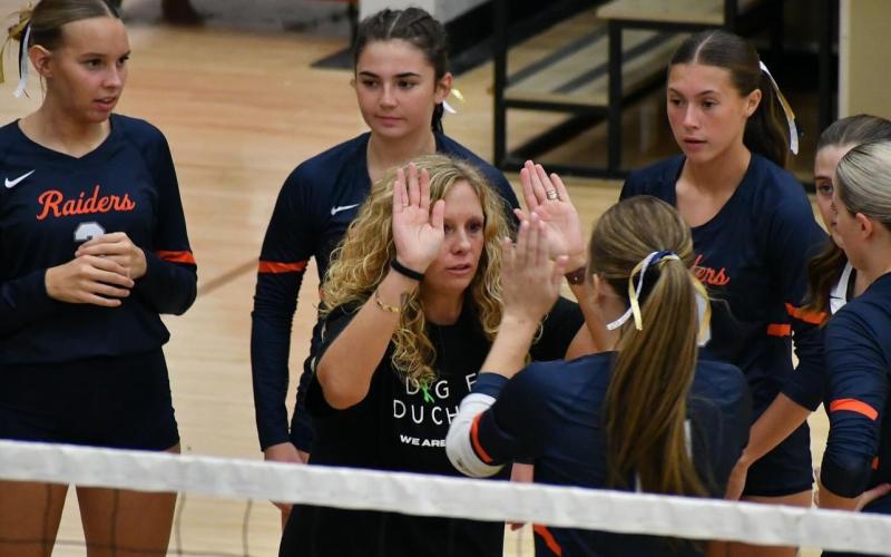 Coach Lindsay Herrin hypes up her team during a timeout. Players wore navy and gold ribbons in their hair to honor Apalachee and the shooting tragedy that took place there earlier this month. LANG STOREY/Special