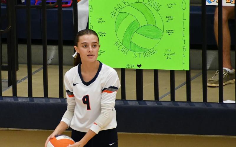 Maci Williams gets ready to serve to Alcovy late last week. Behind her is a sign made to honor Beck Cammarata. LANG STOREY/Staff