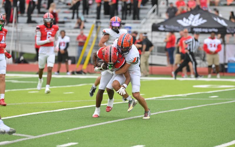 HCHS' Zeke Whittington brings down a Winder ballcarrier Saturday. Whittington also had a big day offensively. TOM ASKEW/Special