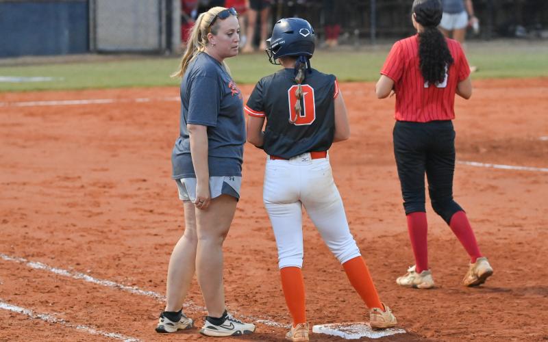Emily Diffenderfer talks strategy with Assistant Coach Ansley Patrum after getting on base last week. TOM ASKEW/Special