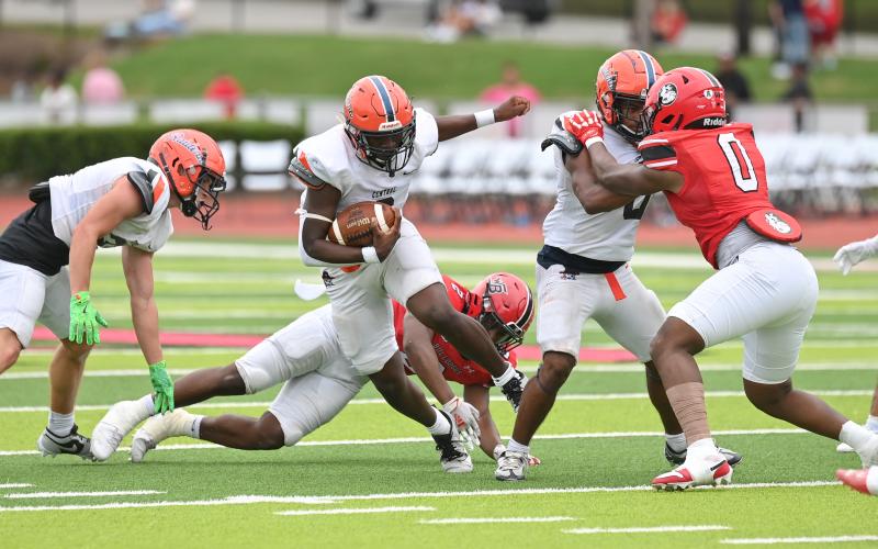 Antonio Cantrell cuts upfield thanks to a key block from Donnie Warren. TOM ASKEW/Special