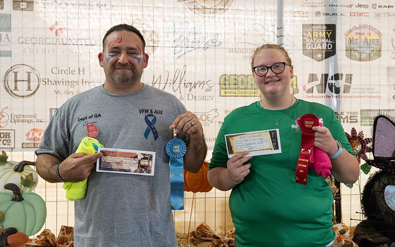 Steven Hawkins and Emmalee Turgeon place 1st and 2nd in the biscuit-eating contest. Hawkins downed four biscuits while Turgeon ate three, with one bite on the fourth, breaking a three-way tie for second place. ZACH TAYLOR/Staff