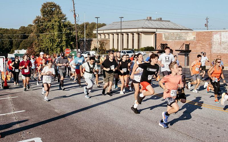 On Saturday, runners begin their journey in the Fried Apple Pie Run 5k on Foreacre Street in Cornelia. The event was the first of its kind in correspondence with the Big Red Apple Festival. ZACH TAYLOR/Staff