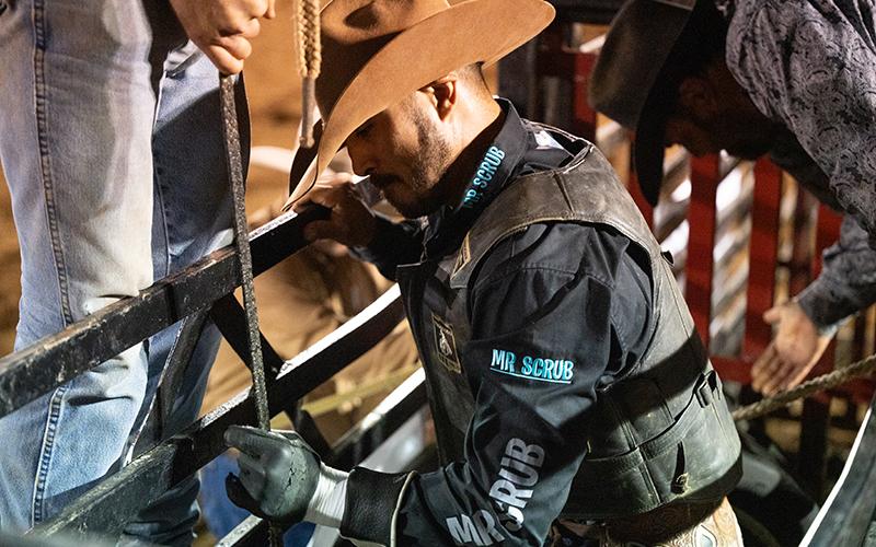 Austin Beaty of Glade Hill, Virginia, gets his hand tacked up with rosin before locking his hands into a rope on a bull on Saturday night. ZACH TAYLOR/Staff