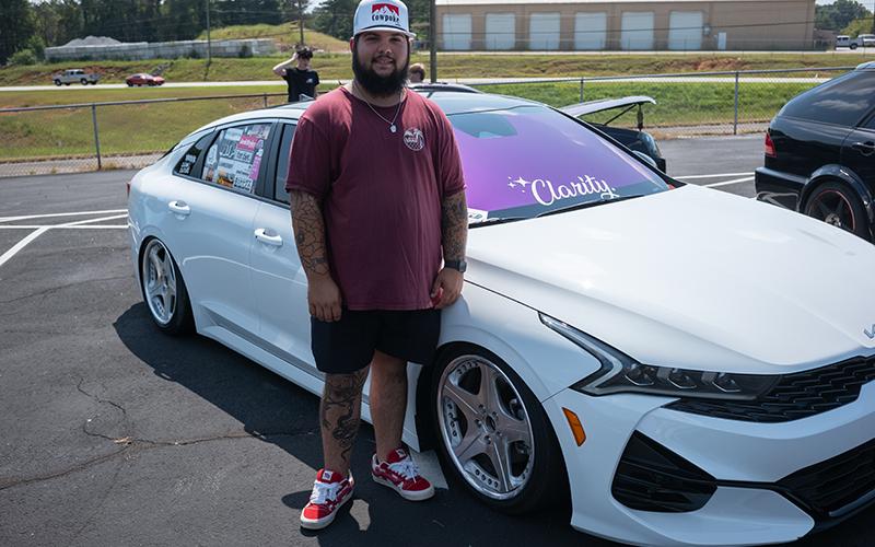 Dylan Lassiter stands beside his custom Kia K5. ZACH TAYLOR/Staff