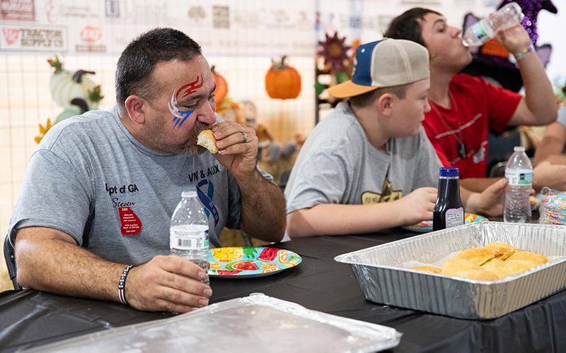 Steven Hawkins stuffs biscuits down during the annual biscuit-eating contest at the Chattahoochee Mountain Fair. Hawkins ate four biscuits in 3 minutes during the competition. ZACH TAYLOR/Staff