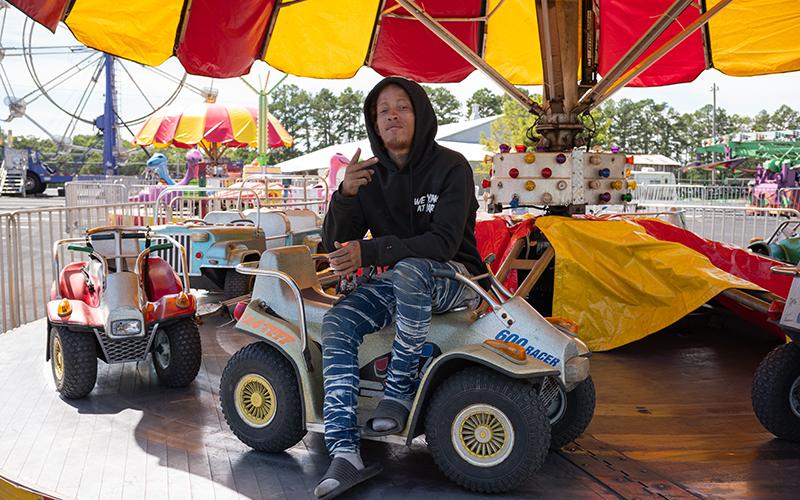 Desmond Pruitt sits on the four-wheeler merry-go-round during a break on Wednesday. ZACH TAYLOR/Staff