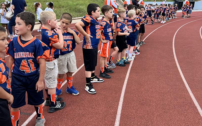 Above, Players from the Habersham rec department NGYFA teams lined the track and formed a tunnel at the last Habersham Central home game. LANG STOREY/Staff