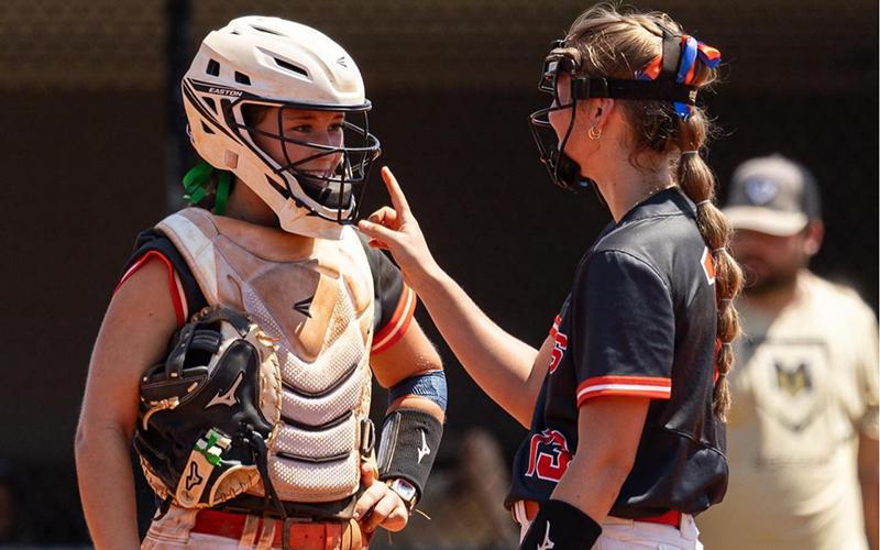 Catcher Shelby Rinefierd chats with Kaylan Barrett during a game earlier this season. MEG LABARBERA/HCHS