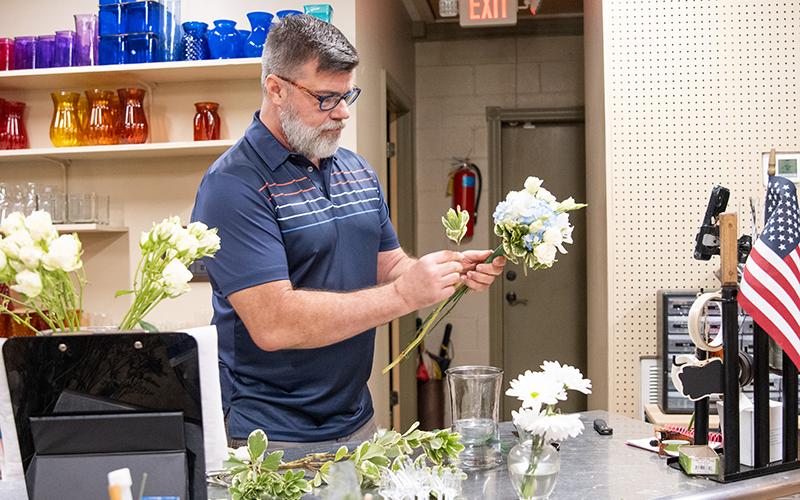 Sidney Martin arranges flowers on Thursday during a work day. Martin has toured the United States with his floristry skills. ZACH TAYLOR/Staff