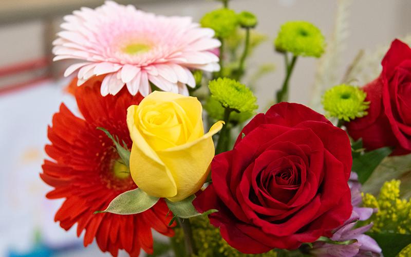 Yellow and red roses and pink and red daisies are included in a homecoming arrangement. ZACH TAYLOR/Staff