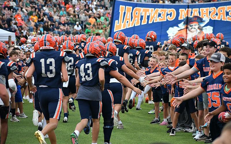 Above, Players from the Habersham rec department NGYFA teams lined the track and formed a tunnel at the last Habersham Central home game. LANG STOREY/Staff
