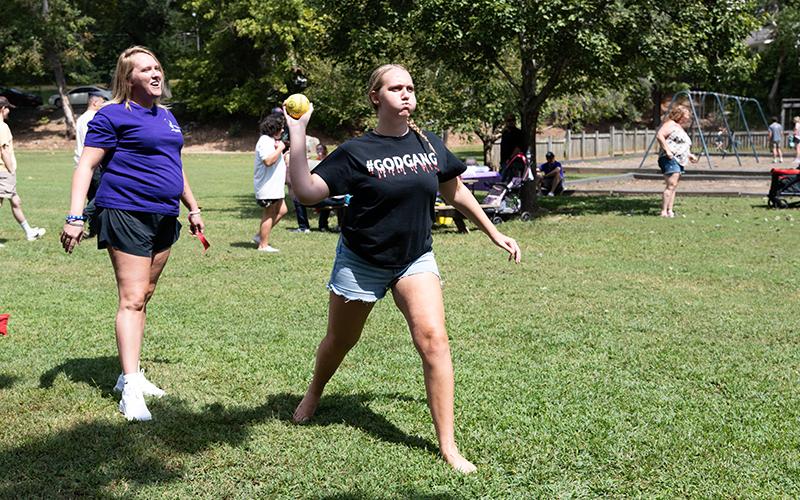 Karly Dean throws a softball alongside Miranda Griffith at the Bounce 4 Joy Inflatables dunk tank target during Recovery Fest 2024. The event featured numerous games, face painting and other fun festivities for families to enjoy. ZACH TAYLOR/Staff