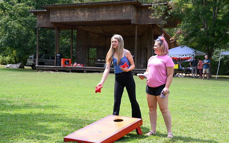 Bailey Ward and Tiffany Young play a game of cornhole at the Recovery Festival on Saturday. ZACH TAYLOR/Staff