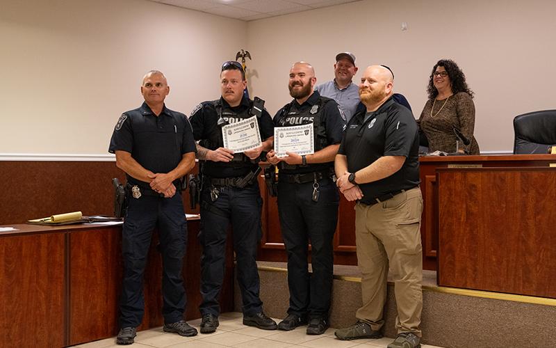 Chief Jones and Assistant Chief Ferguson stand with Corporal John Groves and Corporal Daniel Spivey after the two were honored with Lifesaving Awards at Monday night’s city council meeting. ZACH TAYLOR/Staff
