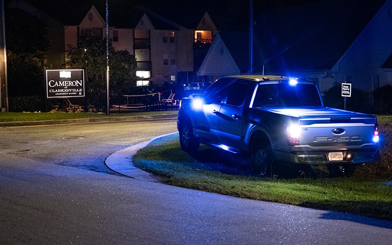 An unmarked law enforcement vehicle sits near the driveway of the Cameron Apartment complex in Clarkesville. ZACH TAYLOR/Staff