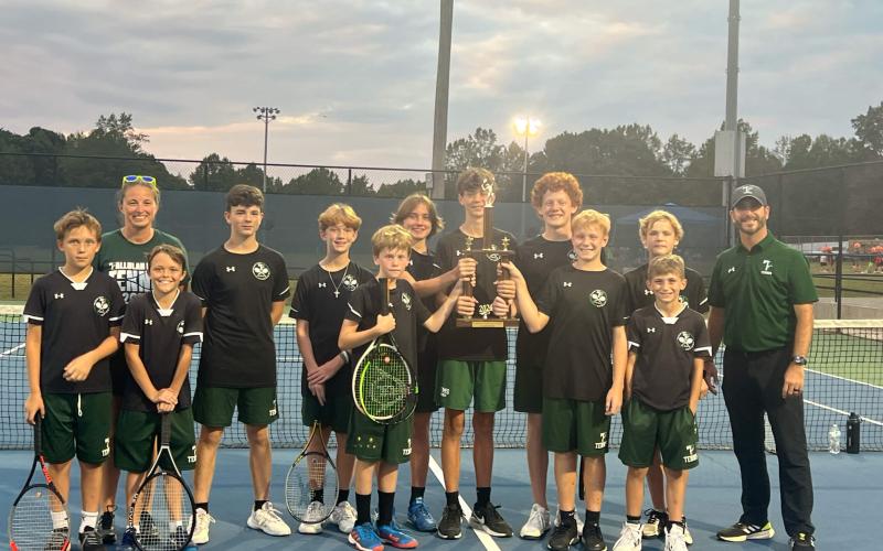 Members of the TFS middle school boys tennis including (from left) Ethan Alderfer, Coach Jennifer Cox, Turner Lander, Maddox English, Isaac Helgeland, Matteus York, Dylan Johnson, Micah Smith, Fenn NeSmith, Jackson Davis, Elijah Pinney, Manager Jase Cox and Coach Anthony Cox celebrate their title run. SUBMITTED