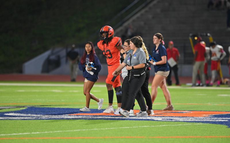 Addison and sports medicine students help Raider football player Aaron Hitchcock off the field during a game this season. TOM ASKEW/Special