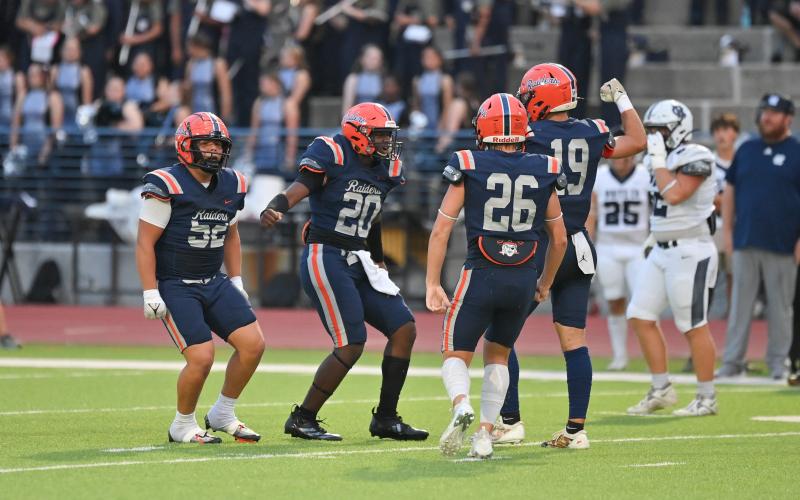 Raider defenders (from left) Anthony Garrido, Griffin Cunningham, Noah Harkins, and Everett Rudeseal celebrate a big stop earlier this season. TOM ASKEW/Special