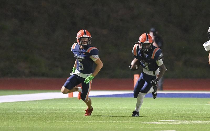 Braydon Strickland (right) returns a kick while Zeke Whittington looks to make a block. TOM ASKEW/Special