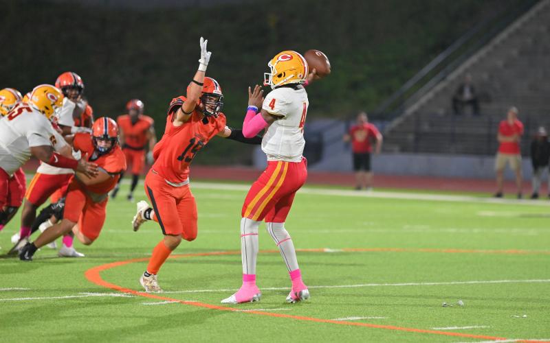 Everett Rudeseal puts pressure on CCHS quarterback Hezekiah Millender. TOM ASKEW/Special