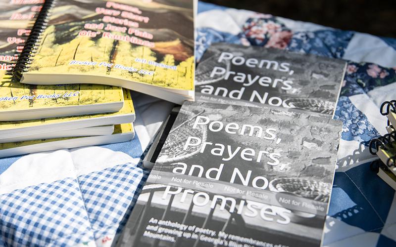 Blackwell’s newest book, Poems, Prayers, and No Promises, sits on a table at the Big Holly Cabin during this year’s rendition of Sticks and Lies. ZACH TAYLOR/Staff